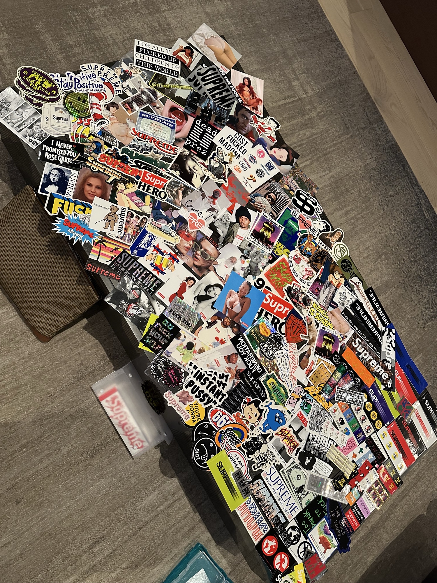 Magazine imagery, stickers, and collectible materials arranged before becoming original artwork