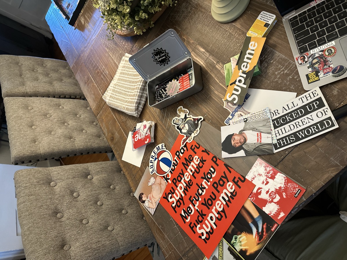 Magazines, stickers, and collectible materials arranged during our creative process