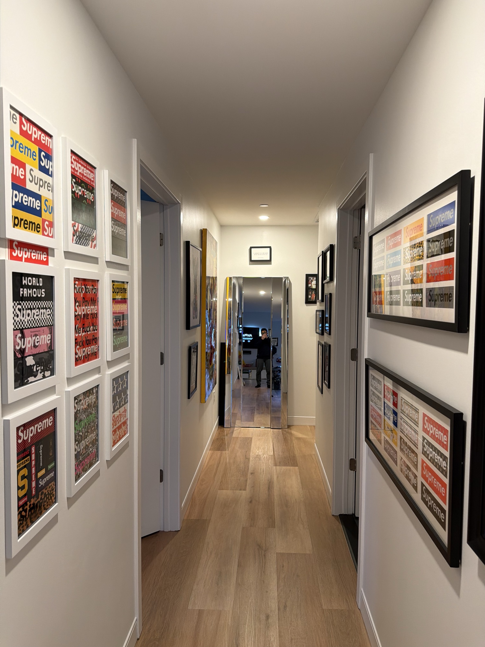 Collector hallway lined with framed sticker and box logo displays