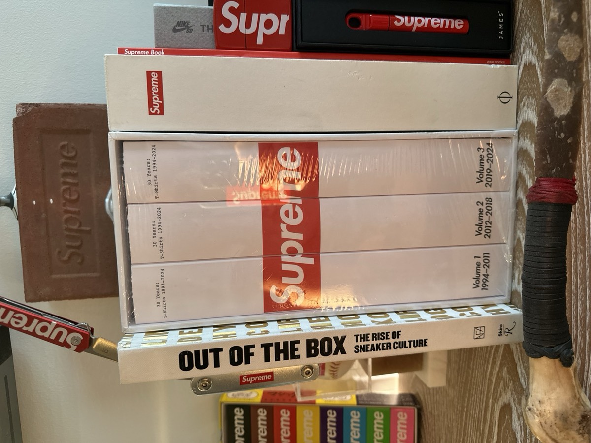 Collector books and brick on shelf