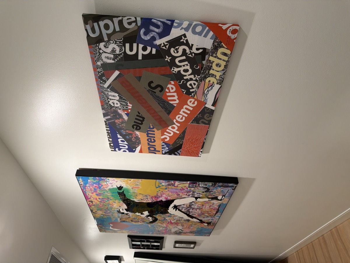 Artwork and collector pieces arranged as a balanced wall grouping