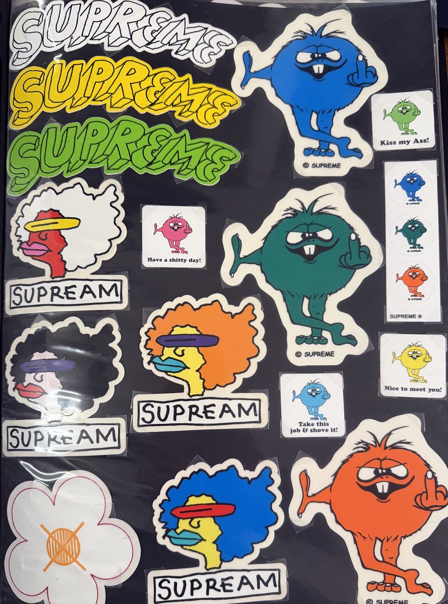Binder page — Supreme script logos, Supream faces, and monster stickers