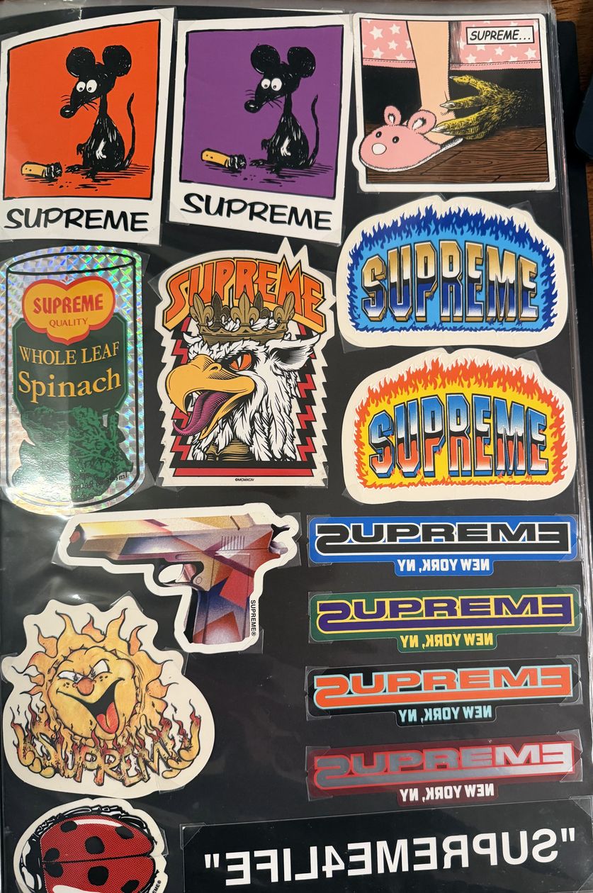 Binder page — spinach can, flame logos, and New York stickers