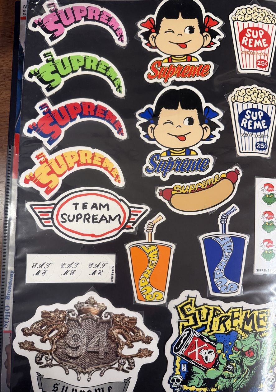 Binder page — Peko, arc logo, and Team Supream stickers