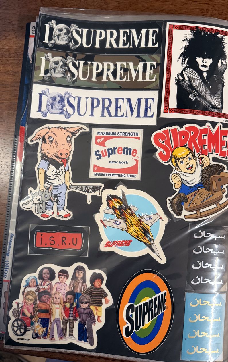 Binder page — I Love Supreme strips, Supreme! kid, and Arabic logo stickers