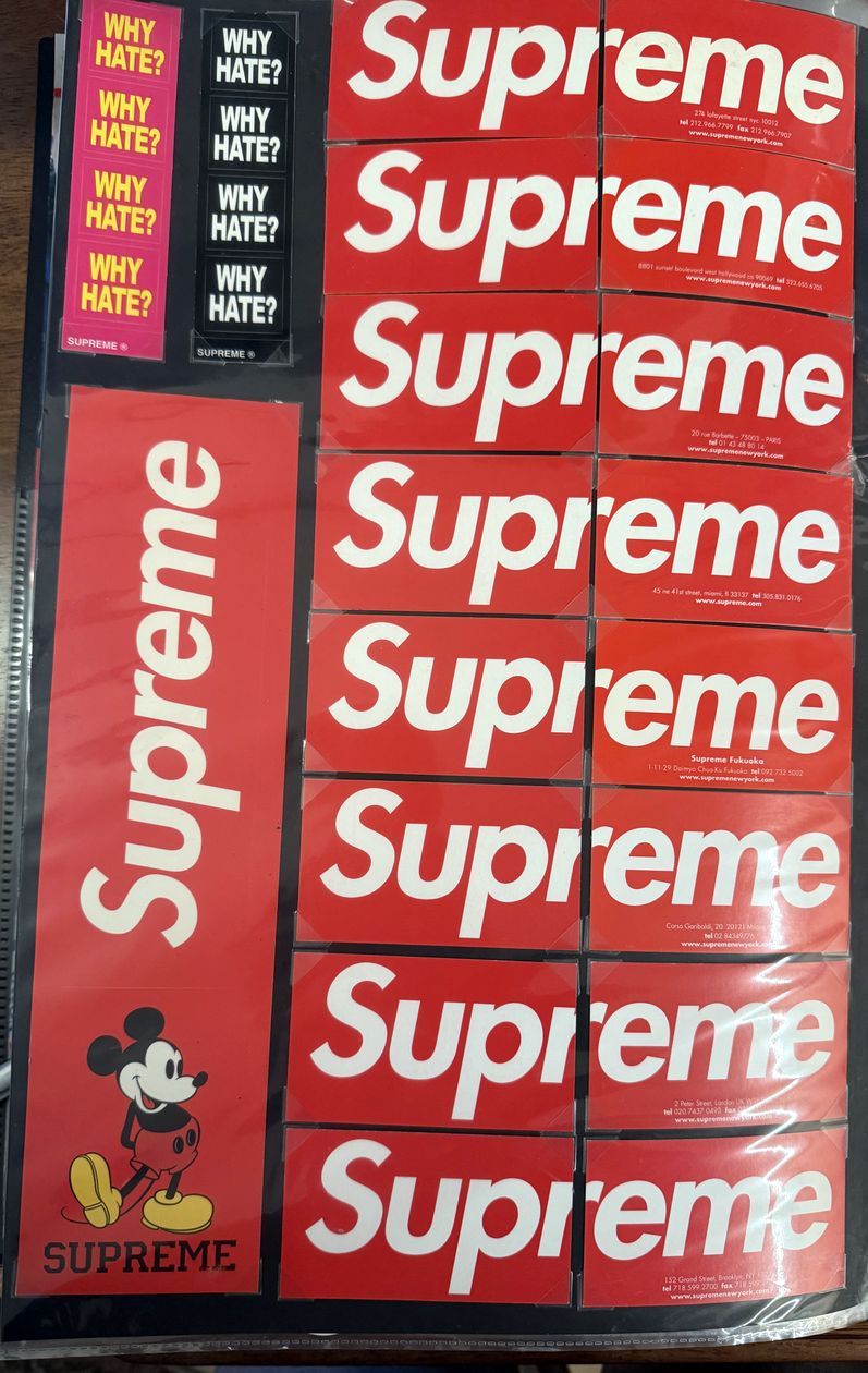 Binder page — red box logo stickers and the Mickey sticker